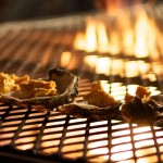 Photo of a barbecue grate with food and flames taken by John Tornow at Smoke Restaurant Dallas